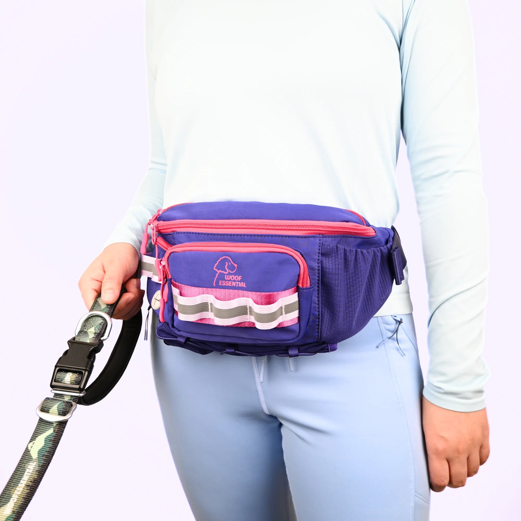 Person wearing a purple and pink waist bag with a dog leash, on a white background