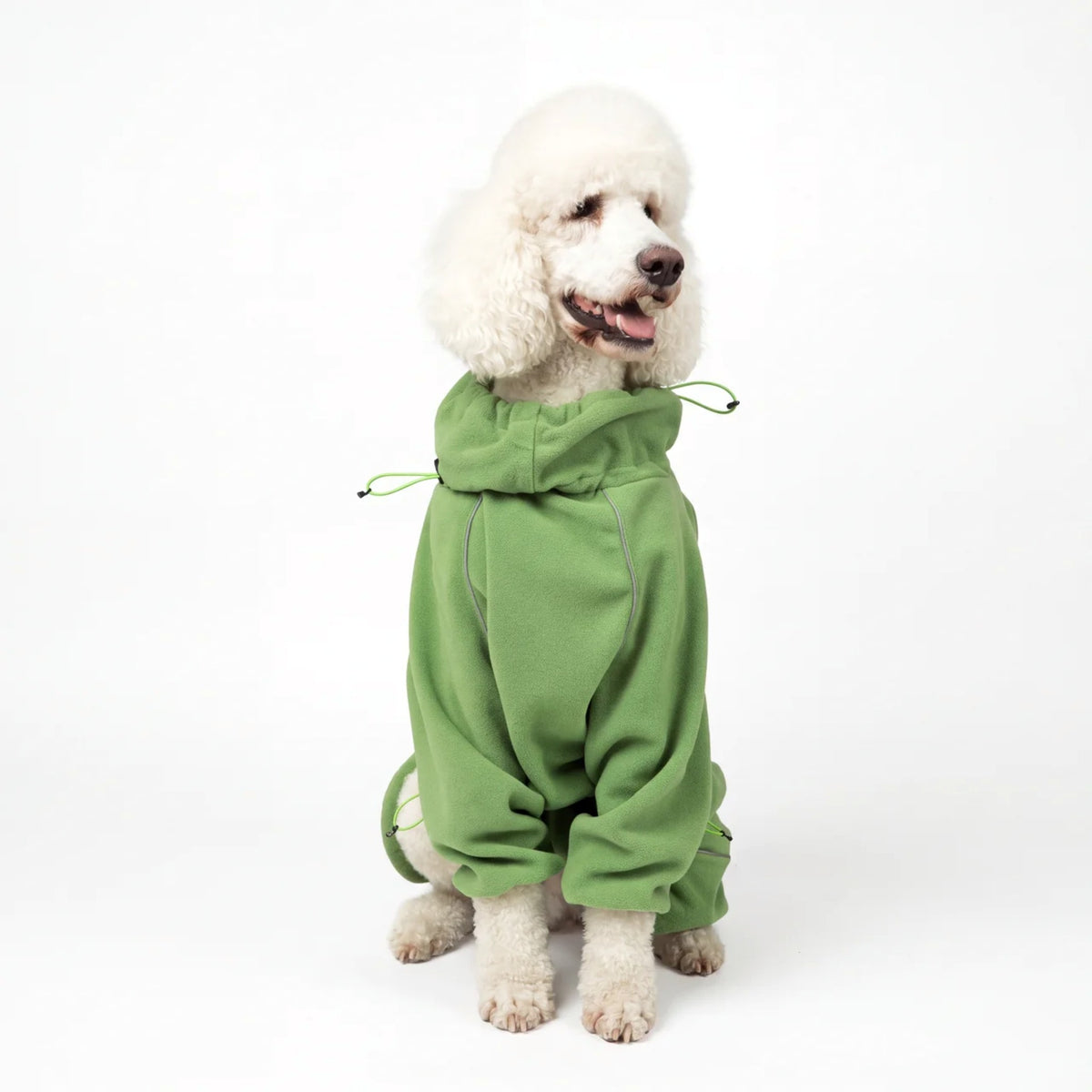 Standard poodle sitting in the Weald Cozy Hugger fleece jacket, front view
