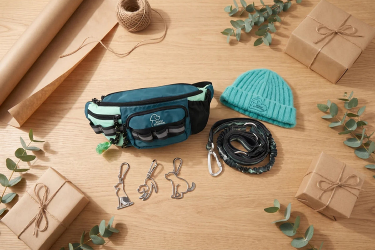 WOOFESSENTIAL walking gear laid out as gifts on a wooden table