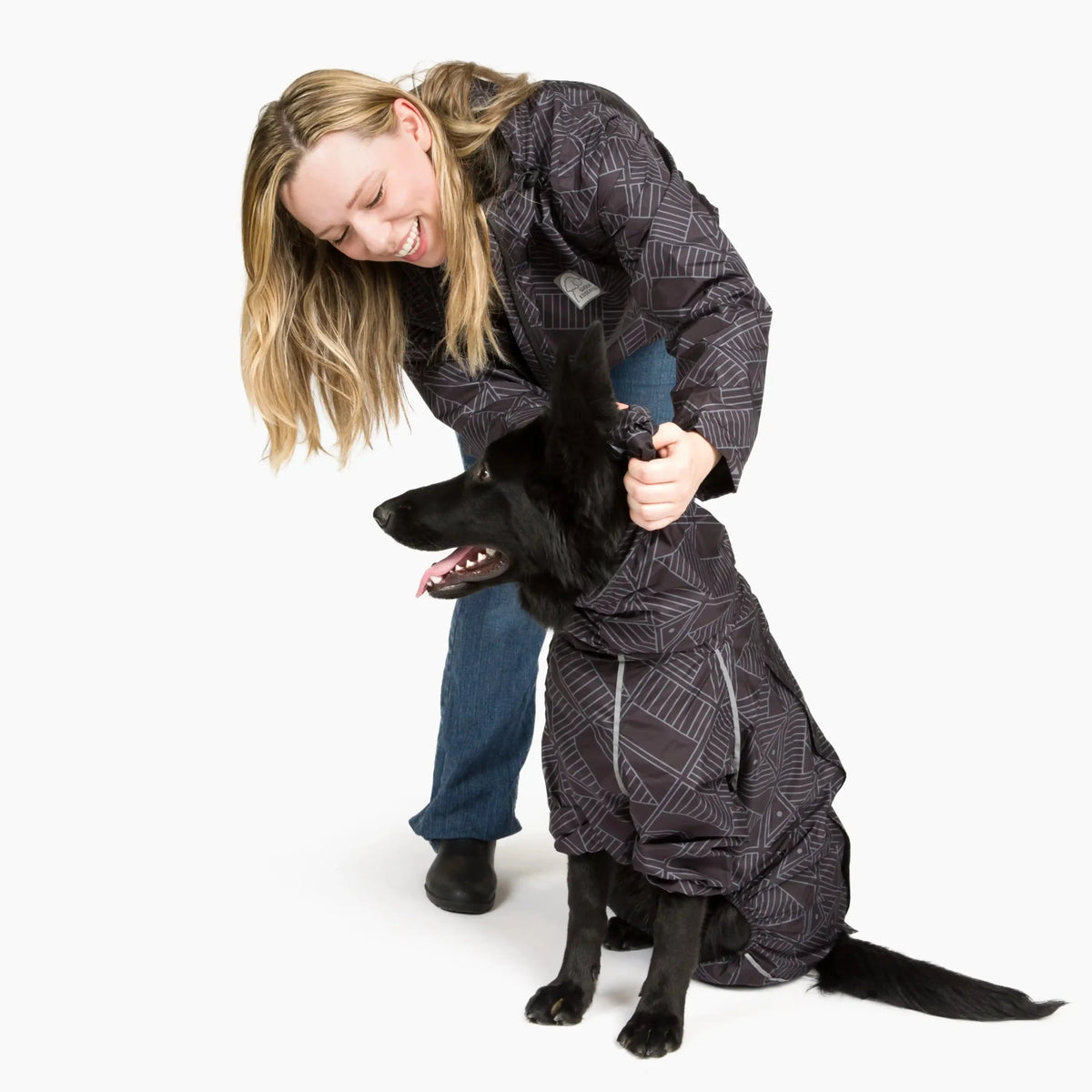 Owner and black dog in matching Eclipse raincoats