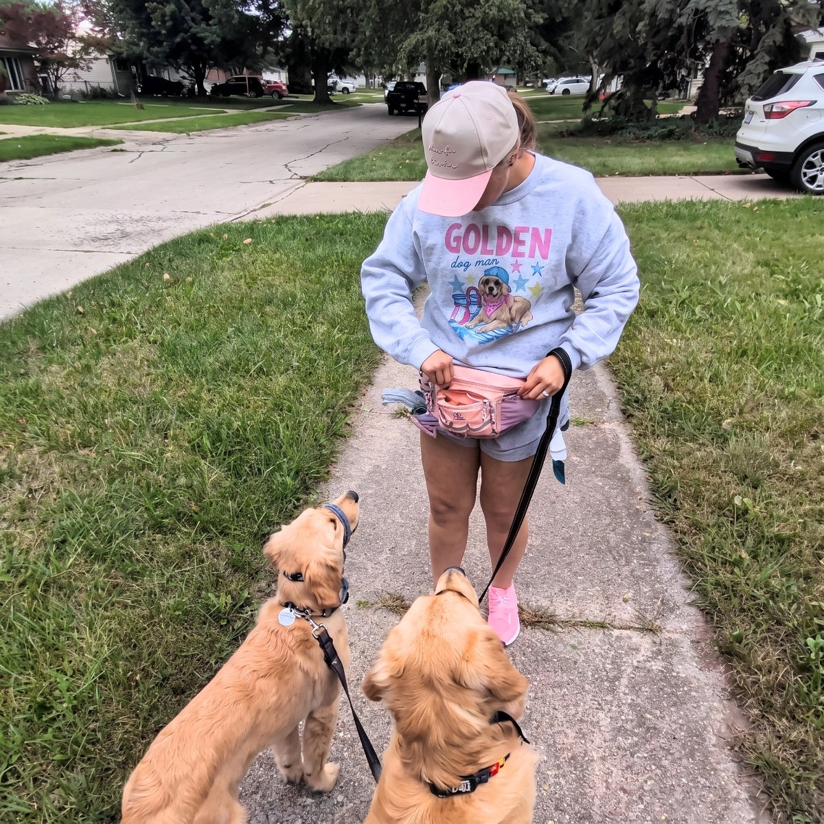 Walking two golden puppies with a pink Hip Pack 2.0