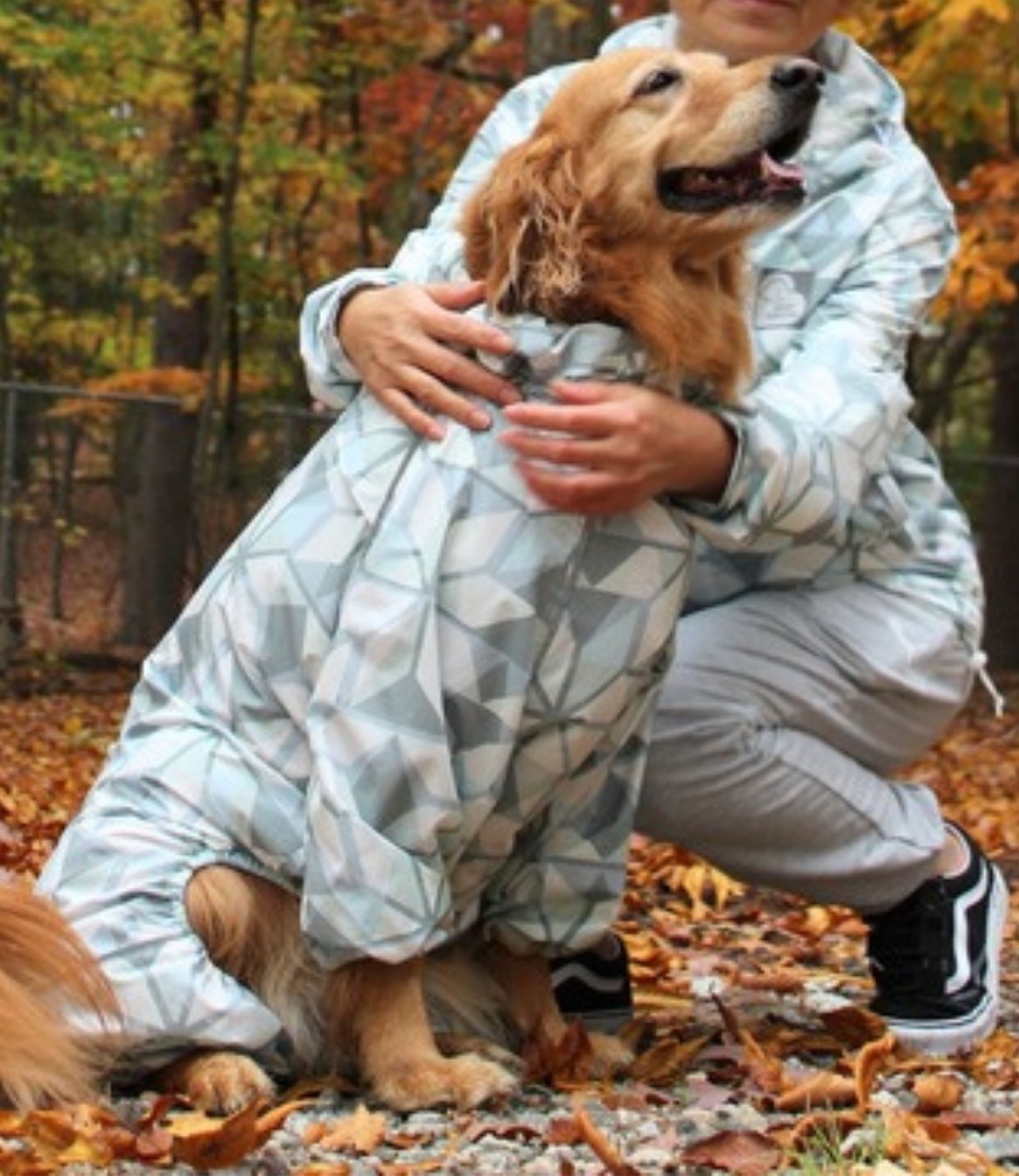Matching dog and human Puddle Jumper raincoats on a rainy walk
