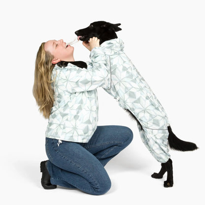 Owner and black dog in matching Overcast Puddle Jumper raincoats 