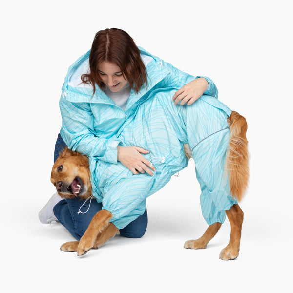 Owner and golden retriever in matching Ripple Puddle Jumper raincoats