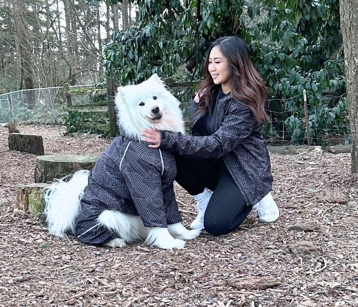 A dog and its owner in matching Eclipse Puddle Jumper raincoats