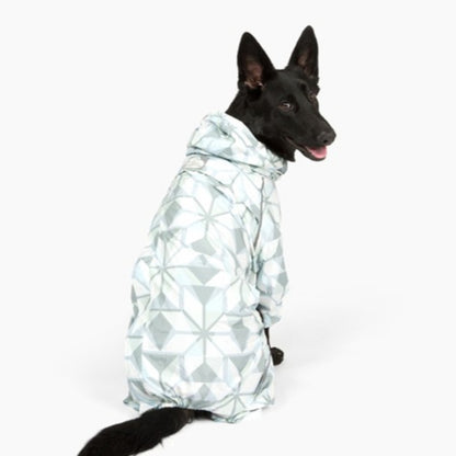 Black shepherd sitting in the Overcast Puddle Jumper raincoat, back three-quarter view 