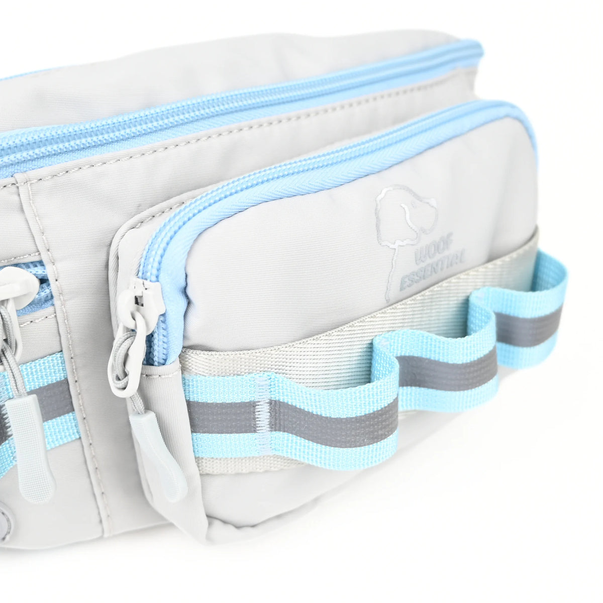 Front zip pocket with daisy chain loops and a reflective strip on a grey dog walking bag